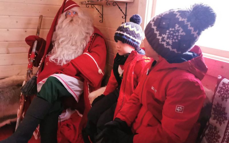 Children visiting Santa in his grotto.