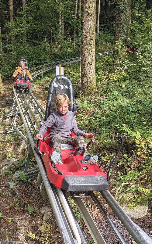 Mother and son on the Fforest Coaster at Zip World Fforest in Wales.