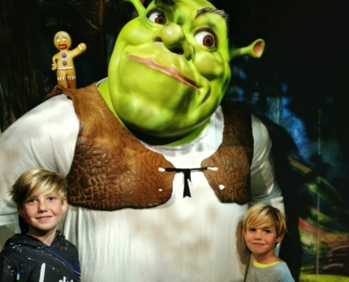 Two young boys standing in front of a large Shrek for my review of Shrek's Adventure in London.