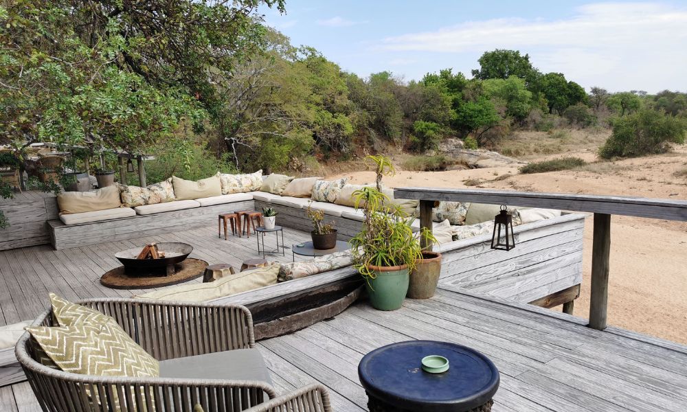 Decked lounge area at Thornybush Game Lodge overlooking a dry riverbed.