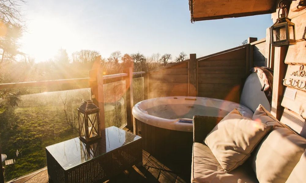 Hot tub on the balcony of the Orchard Treehouse at Bredon Hill treehouses in the Cotswolds.