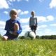 Photo of two young footballers taken from grass level.