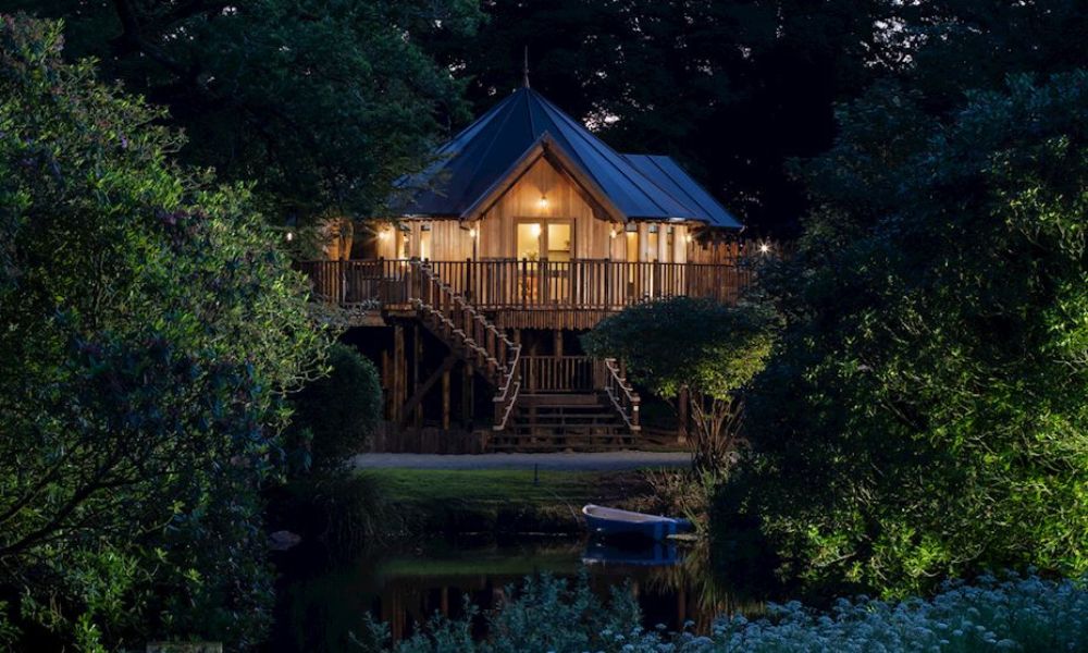 View of the treehouse across the lake at Landal Clowance in Cornwall.