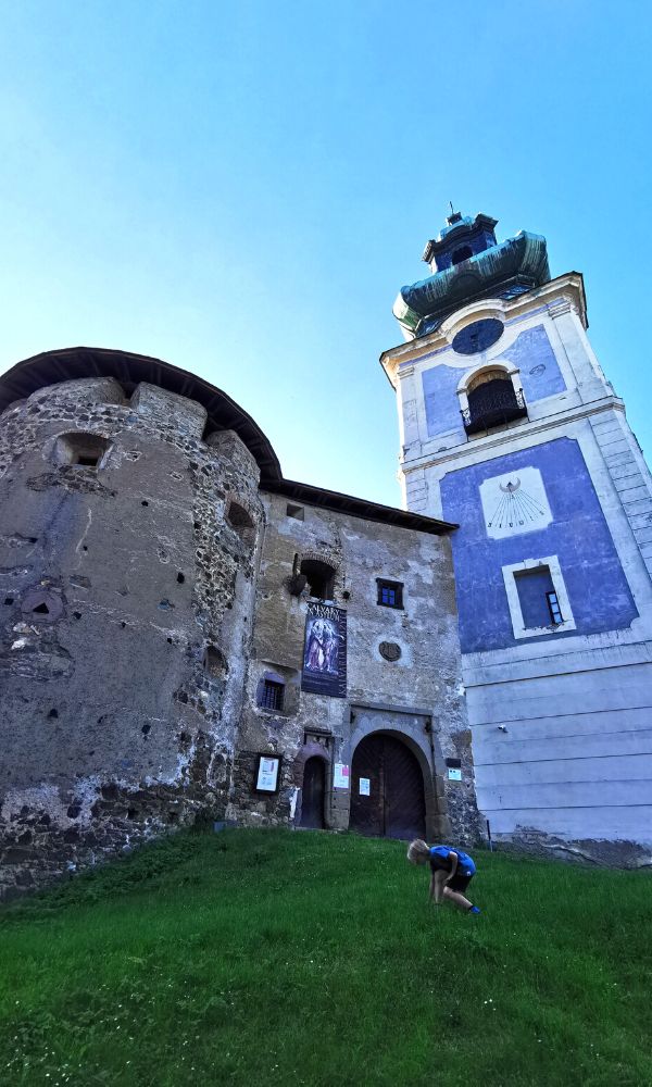 Child playing on the hill in front of The Old Castle in Banska Stiavnica in Slovakia.