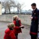 Kids buying a guide book at the Tower of London.