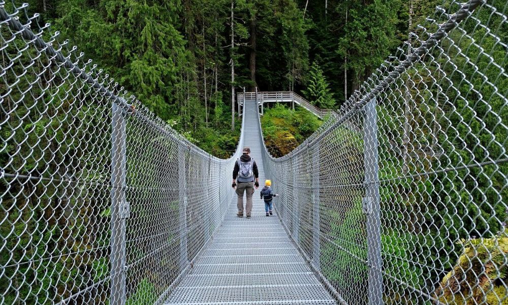 Man and toddler crossing the Elk Falls Suspension Bridge on Vancouver Island.