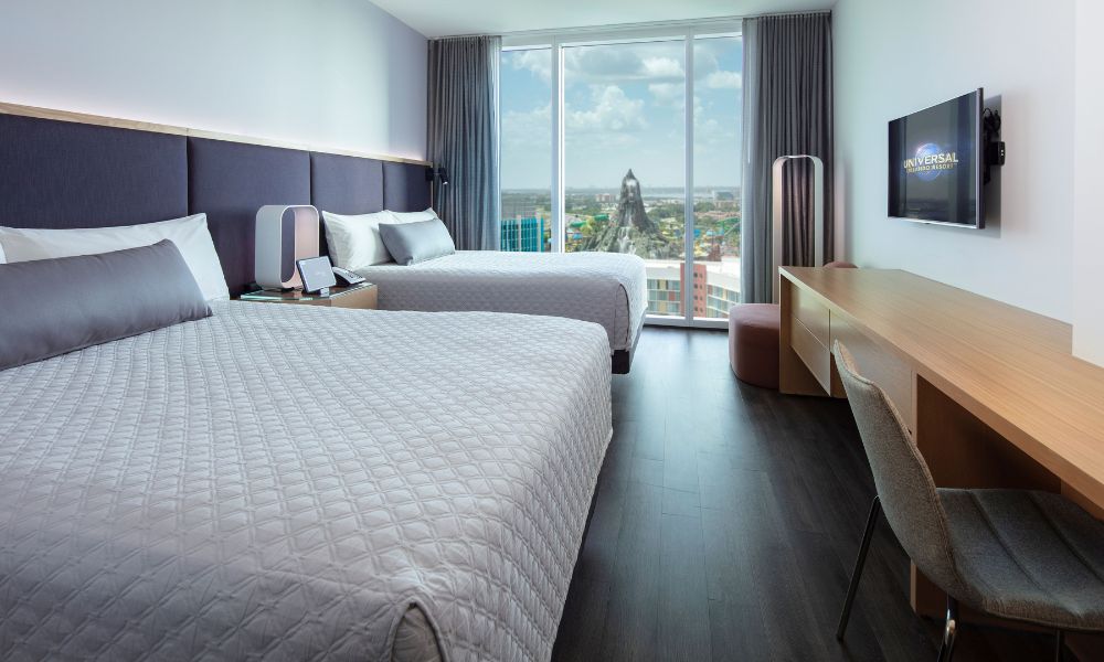 Guest room at Universal's Aventura Hotel in Orlando with view of Volcano Bay out of the window.