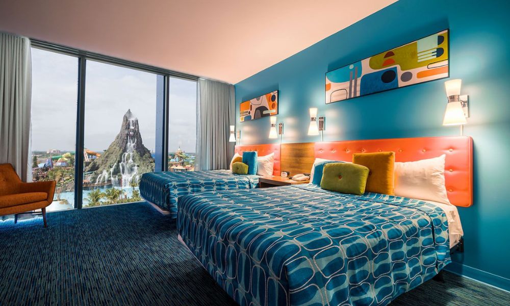Guest room with two queen beds and view of Volcano Bay at Universal's Cabana Bay Hotel in Orlando.