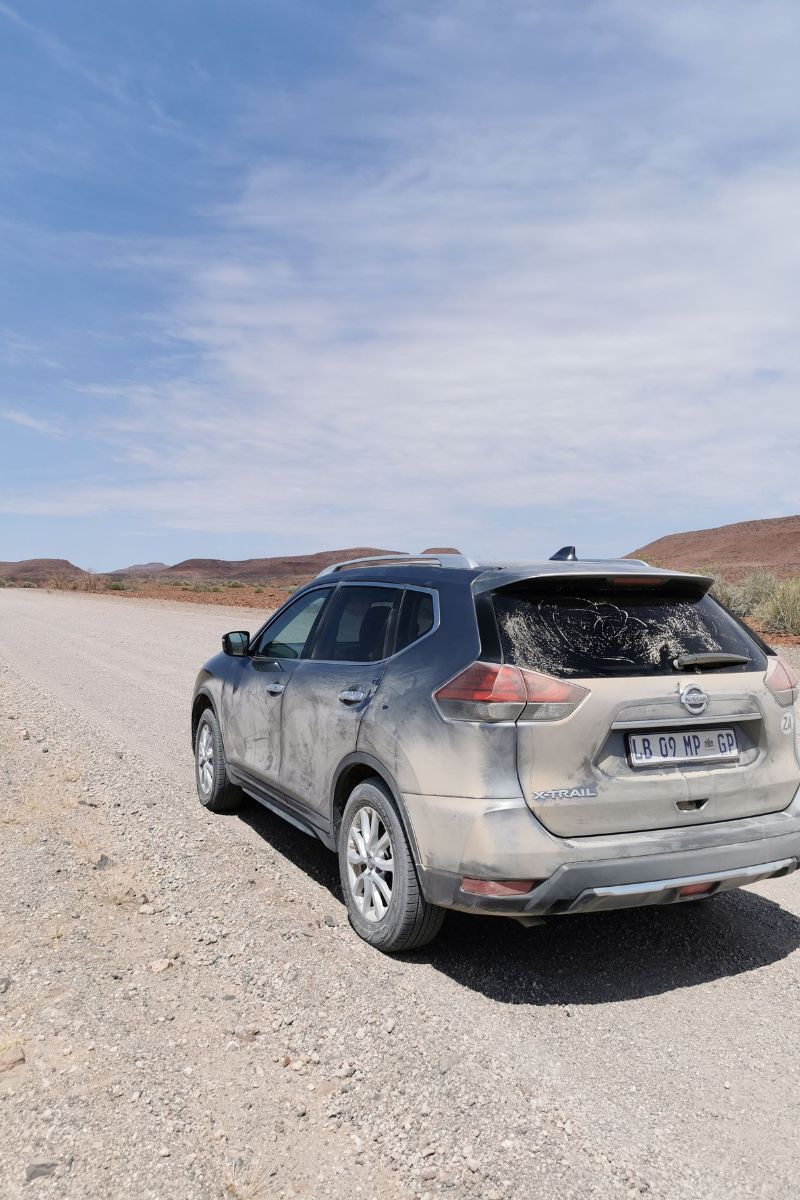 Dusty Nissan XTrail on a gravel road in Namibia during a two week Namibian road trip.