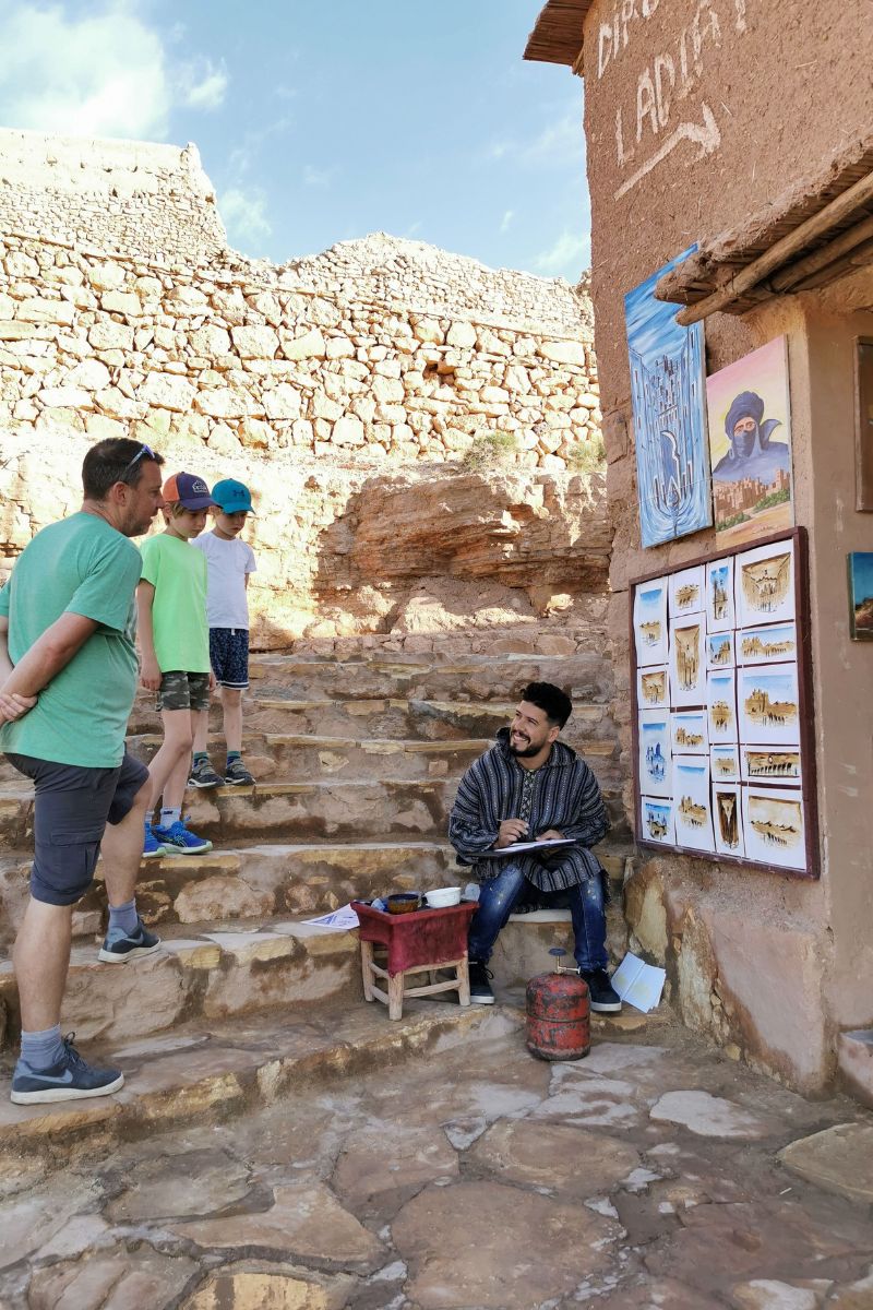 Berber man using ancient caramel painting technique in Ait-Ben-Haddou in Morocco.