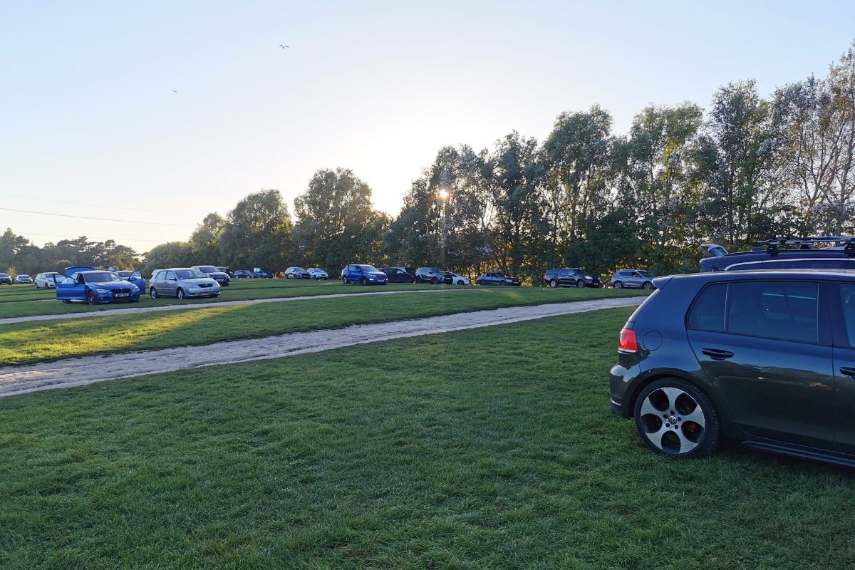 Cars parked in a field in the car park at Chessington World of Adventures Resort.