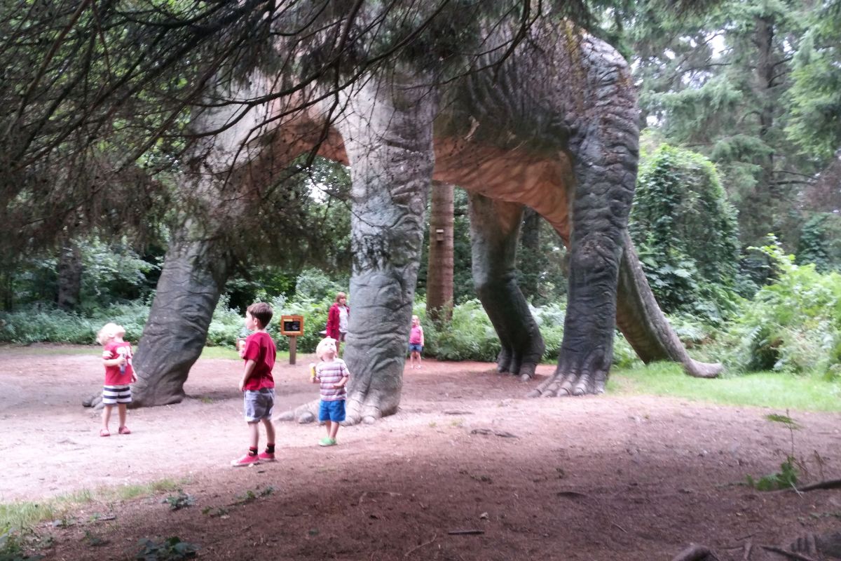 Small kids underneath the Brachiosaurus at Roarr! in Norfolk - one of the best things to do in Norfolk with kids.