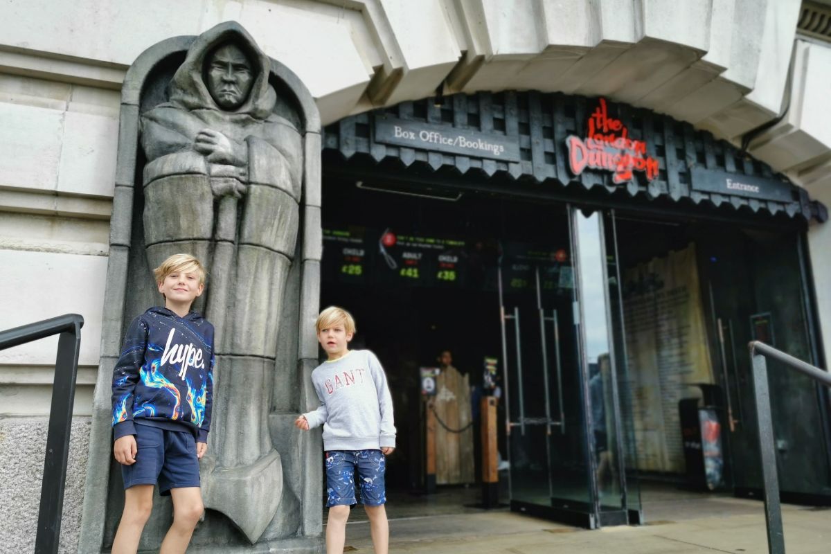 Two boys visiting the London Dungeon - one of the best things to do at Halloween in London for kids.