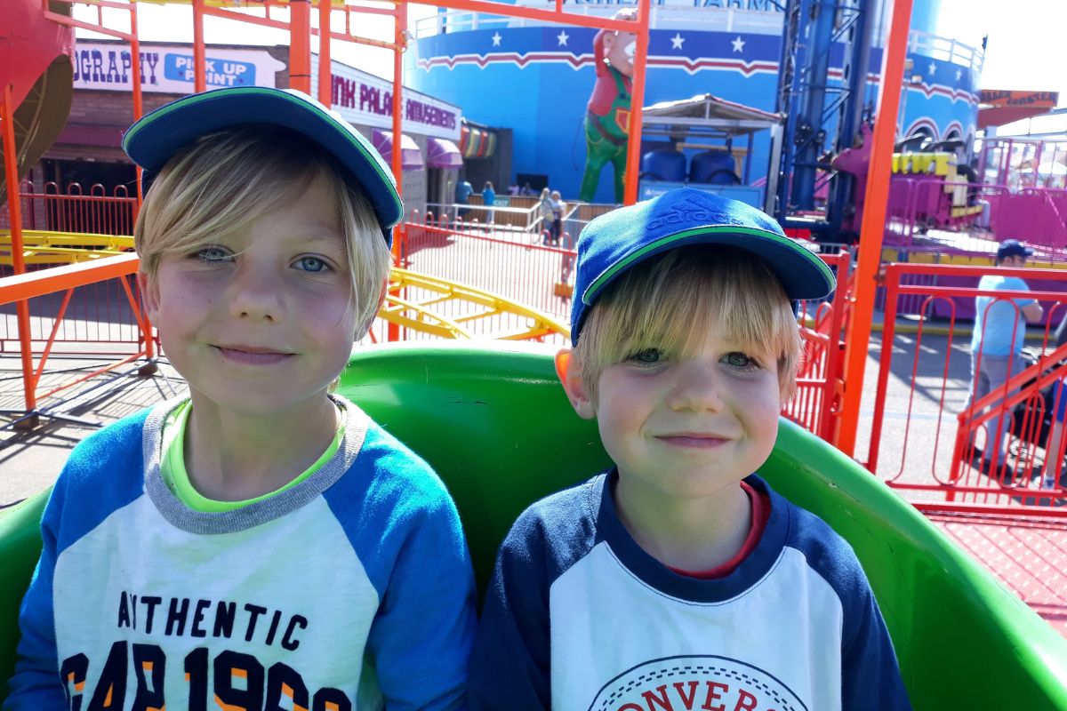 Two young boys on a rollercoaster at Great Yarmouth Pleasure Beach - one of the best days out for families in Norfolk.
