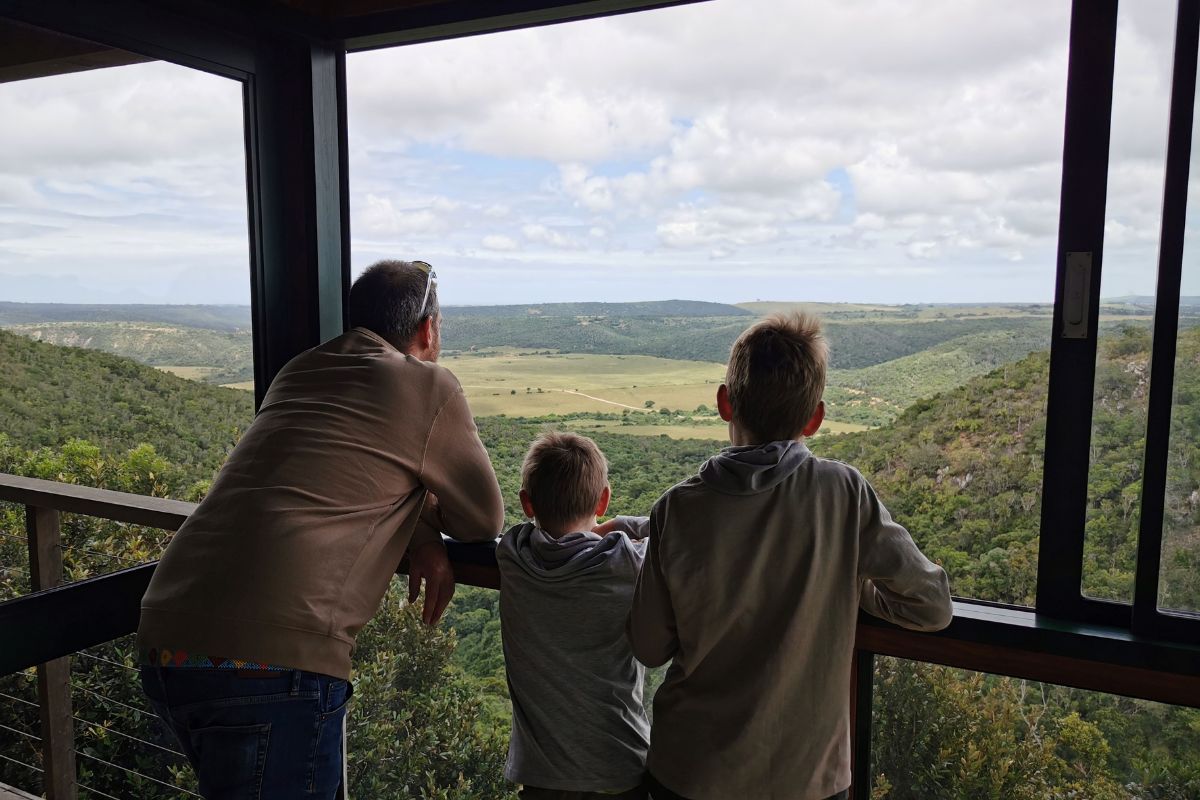 Family looking at the view of Kariega Game Reserve from Kariega Main Lodge.